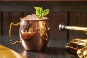 A Moscow Mule cocktail in a traditional copper mug